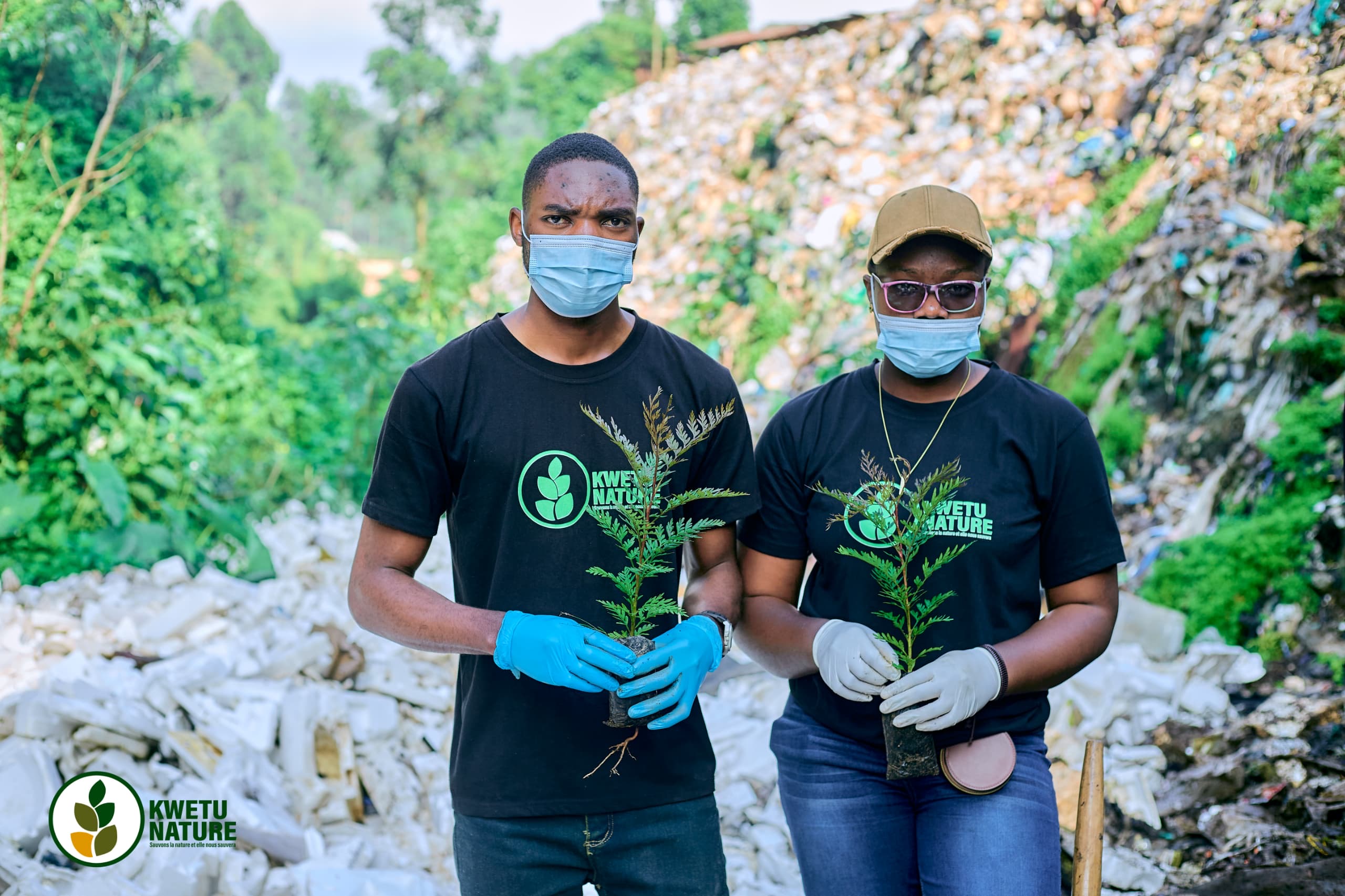 two Young members of Kwetu Nature displaying anti-erosion plants before planting them